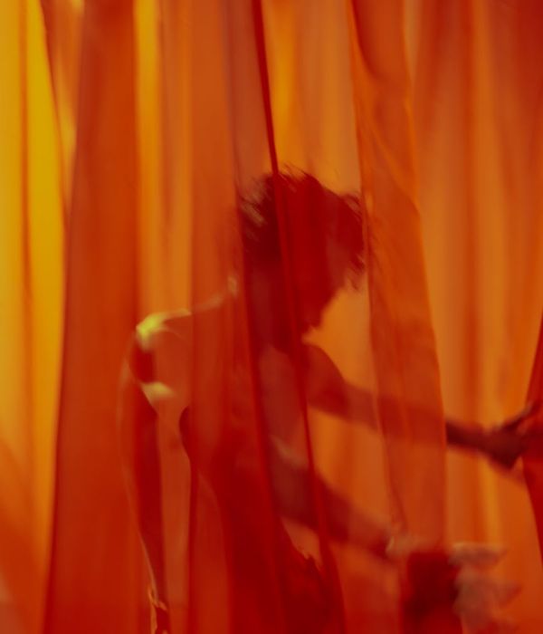 Person performing a fluid cardio movement in a minimalist space.